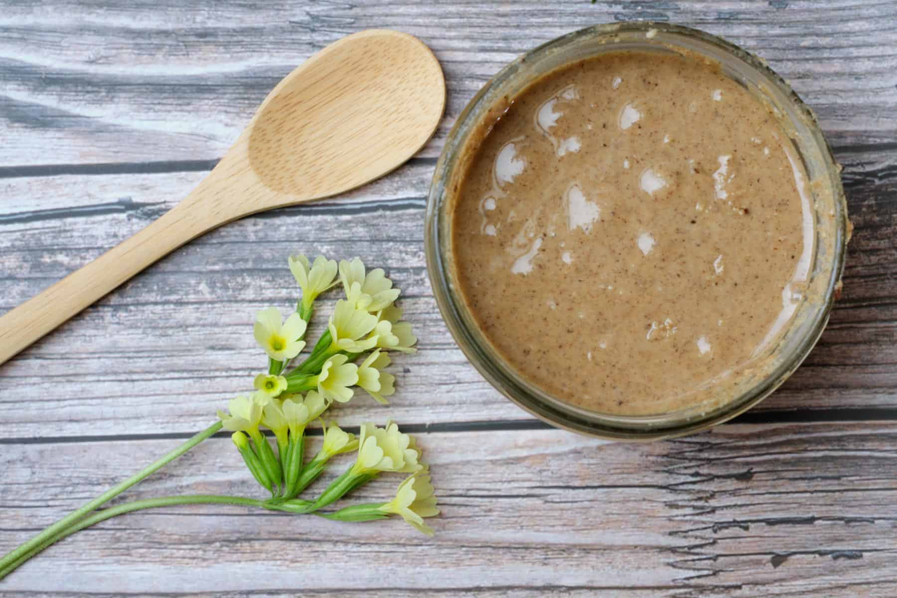 Jar with nut butter and a yellow flower