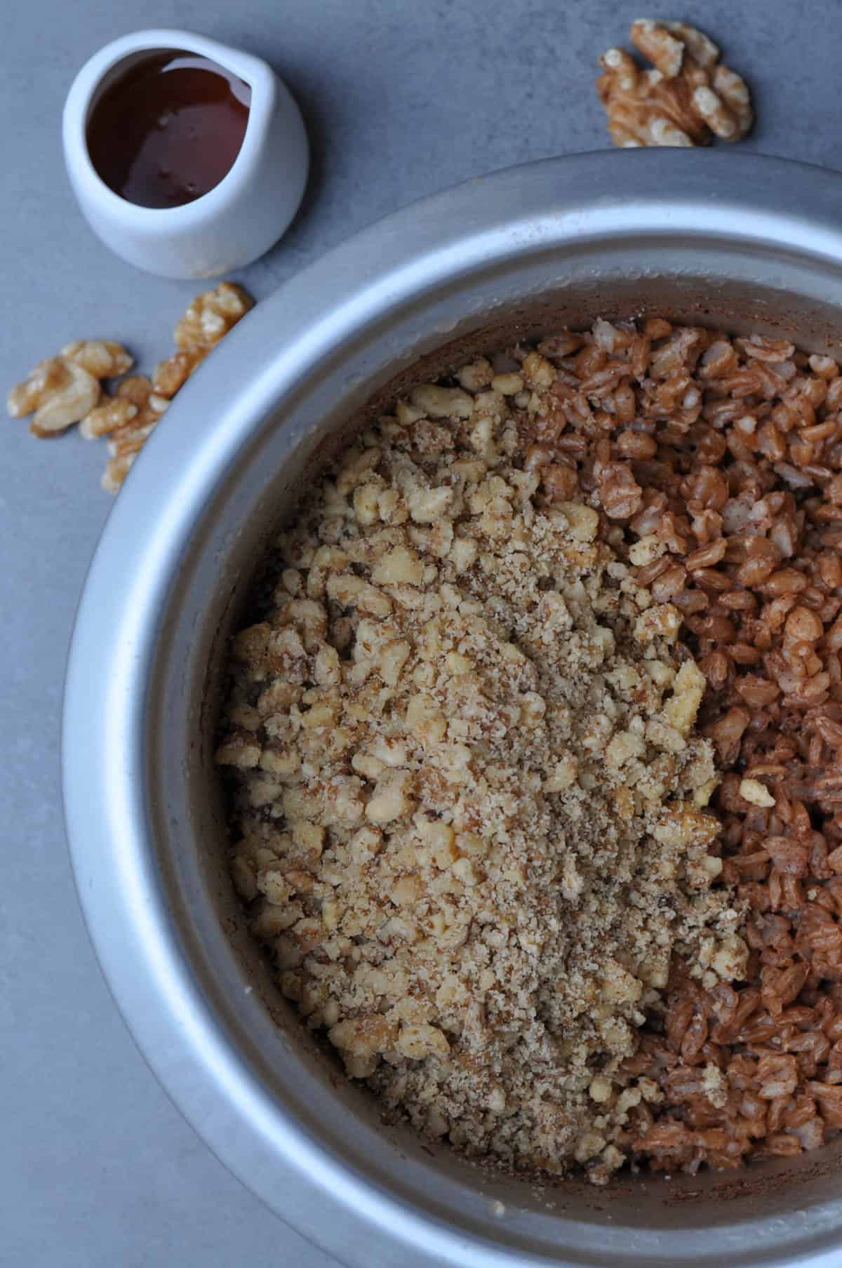 Cooked farro in a rice cooker with walnuts and maple syrup aside