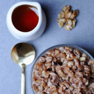 Glass with farro dessert and golden spoon