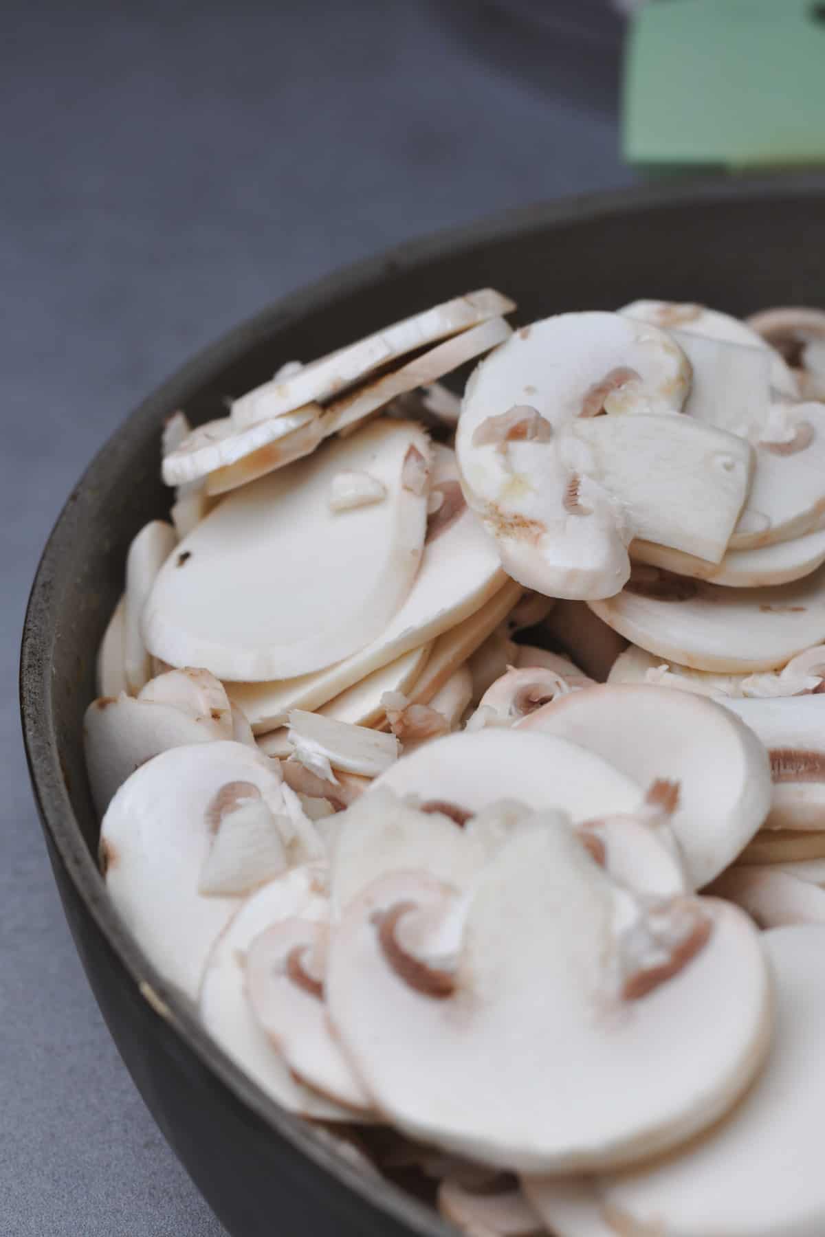 sliced champignon mushrooms in a pan
