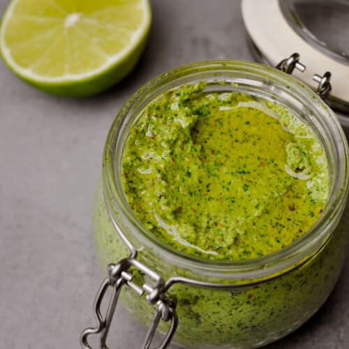 vegan arugula pesto in a small jar.