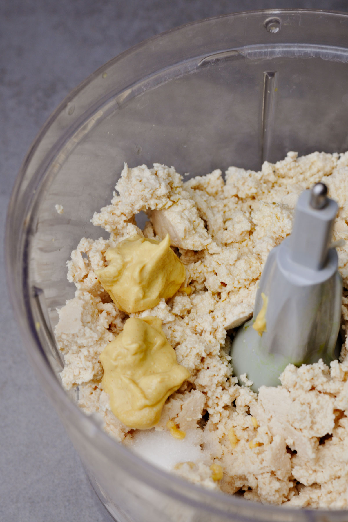 Crumbled tofu, Dijon mustard and salt in a food processor