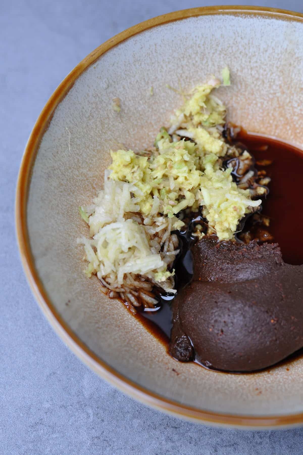 Miso, ginger, garlic, and soy sauce in a small bowl