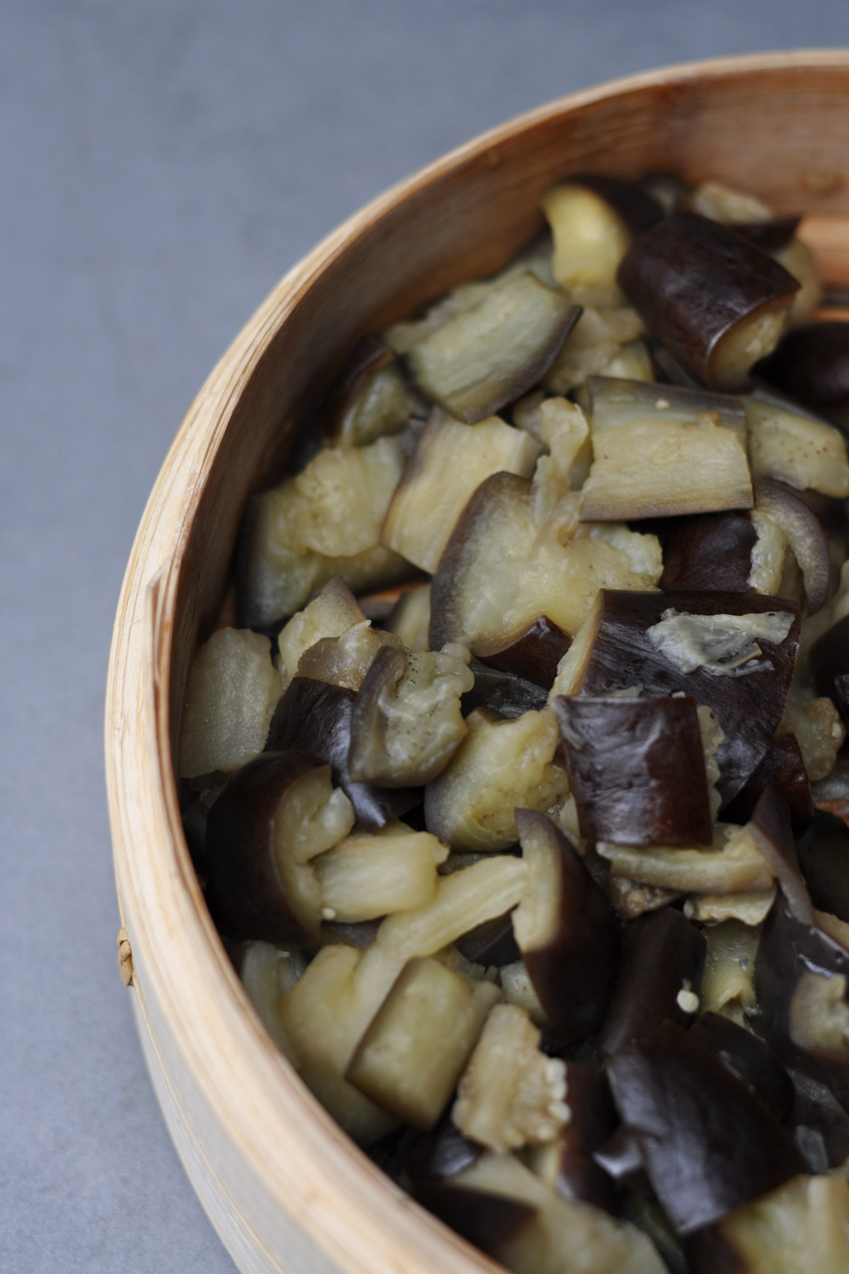 Steamed aubergine in a bamboo steamer