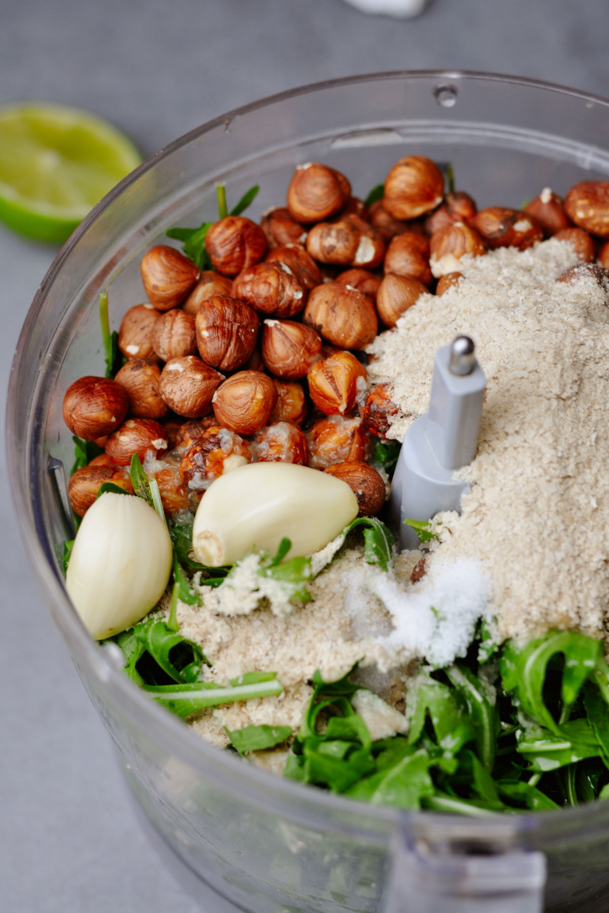 arugula, garlic, hazelnuts and nutritional yeast in a food processor