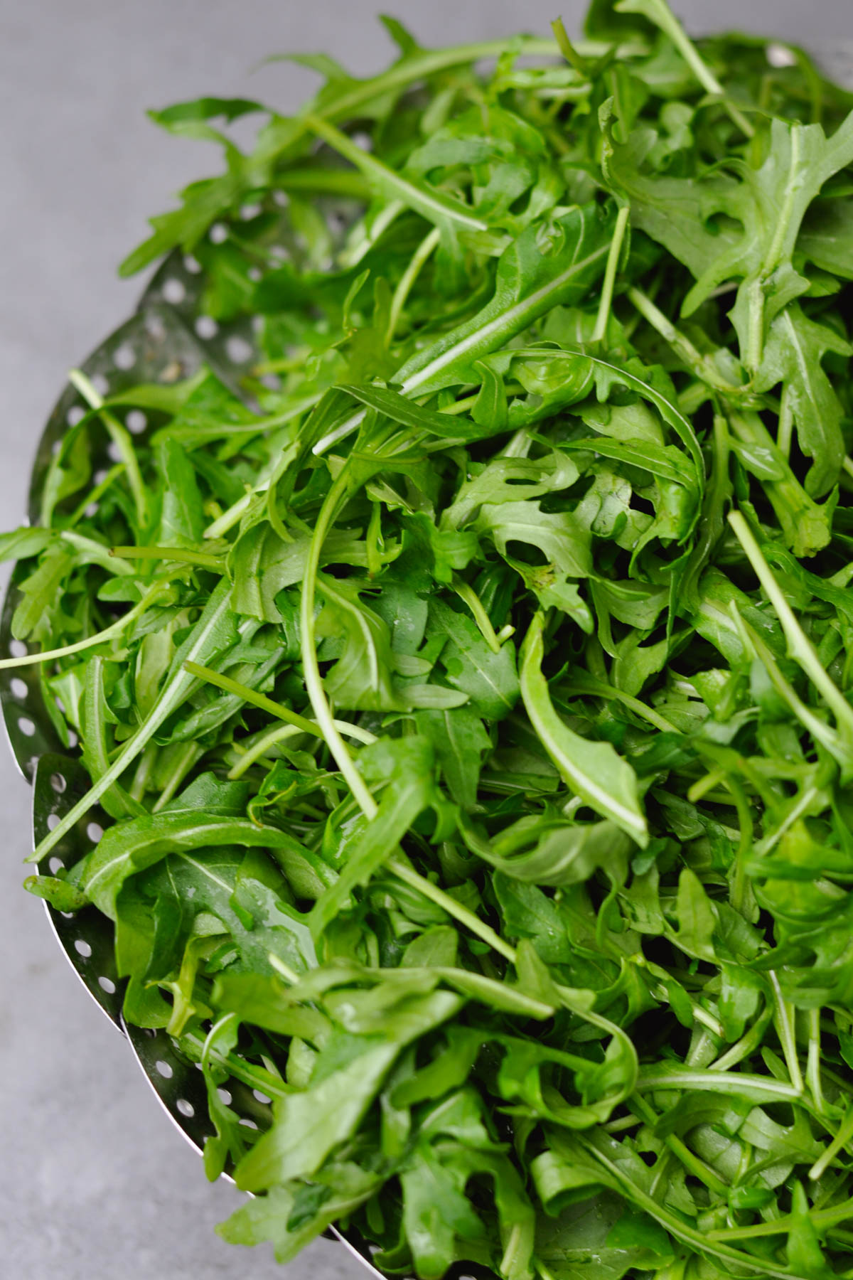 washed arugula in a colander