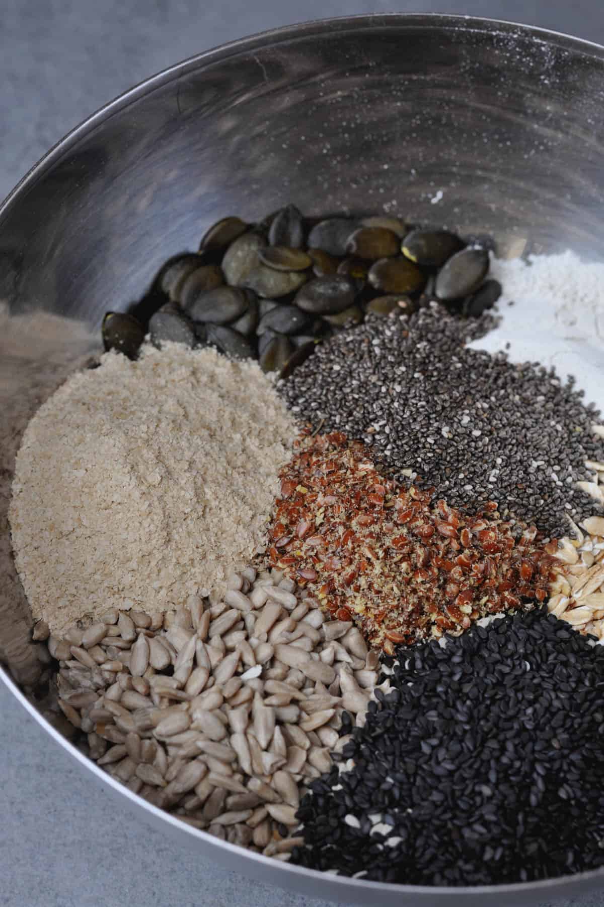 Seeds, oats, nutritional yeast, flour in a bowl-ingredients for Multi-Seed Crispbread (Knäckebröd)