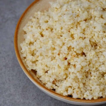 cooked perfect fluffy millet in a bowl.