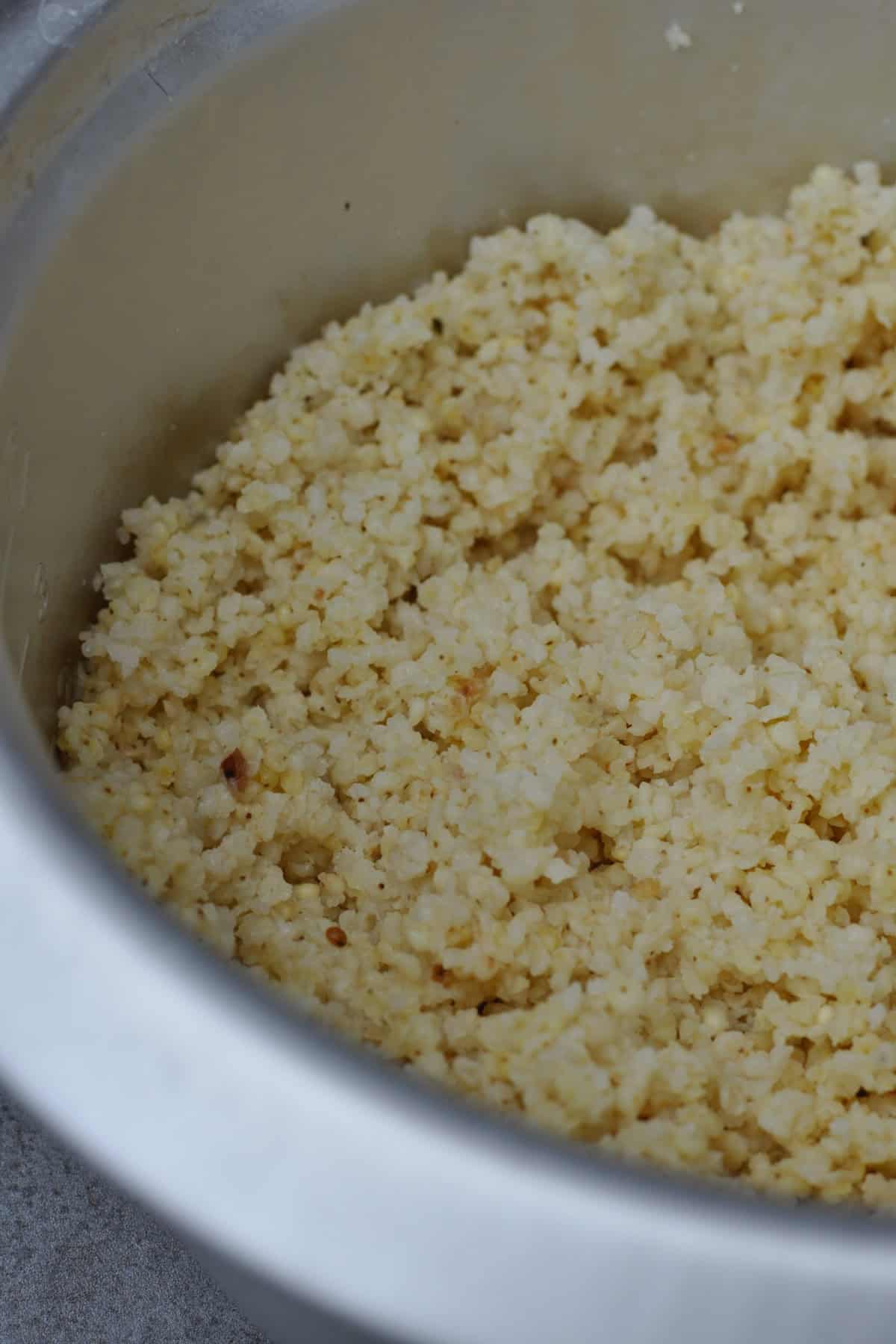 cooked fluffy millet in a rice cooker bowl