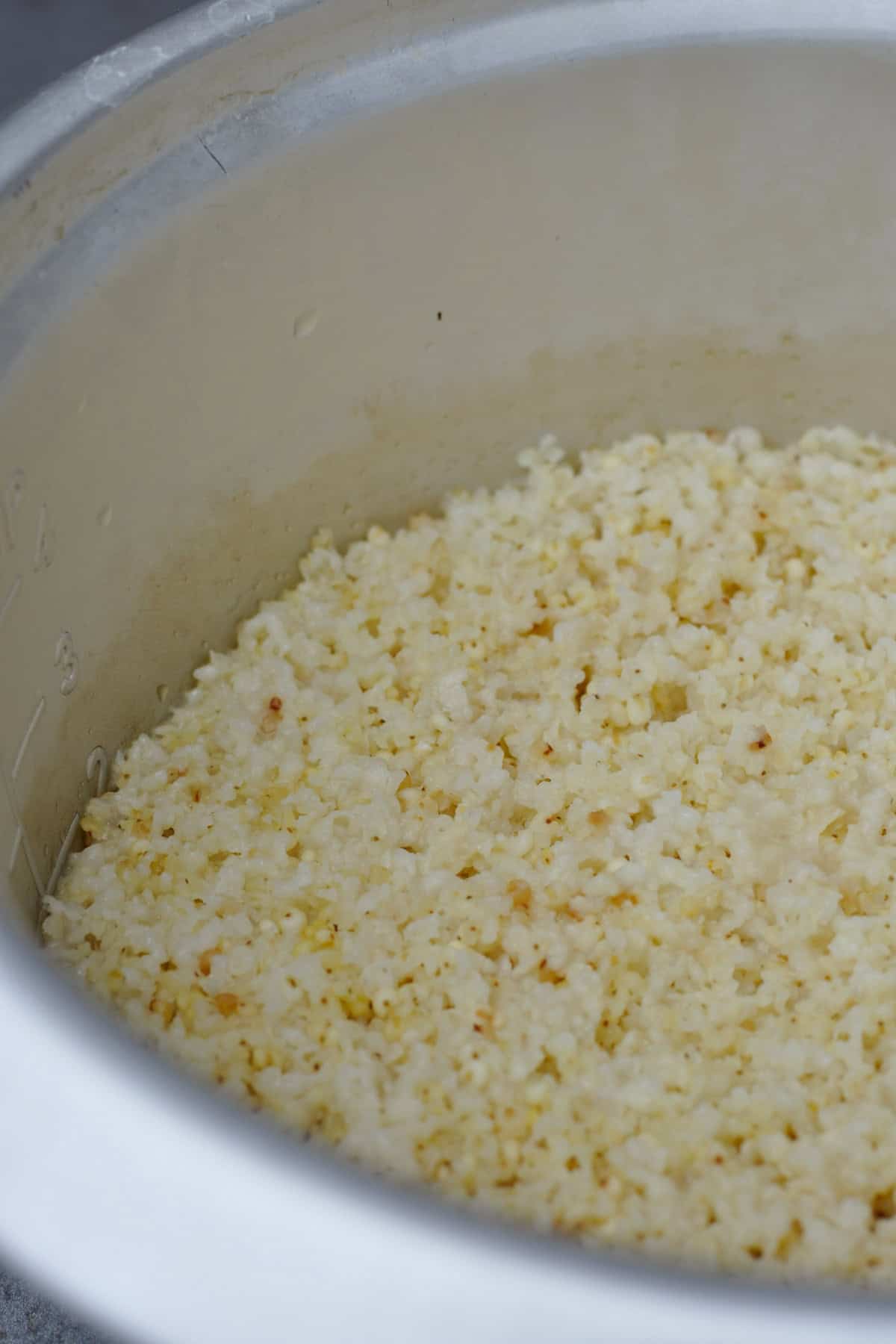 cooked fluffy millet in a rice cooker bowl