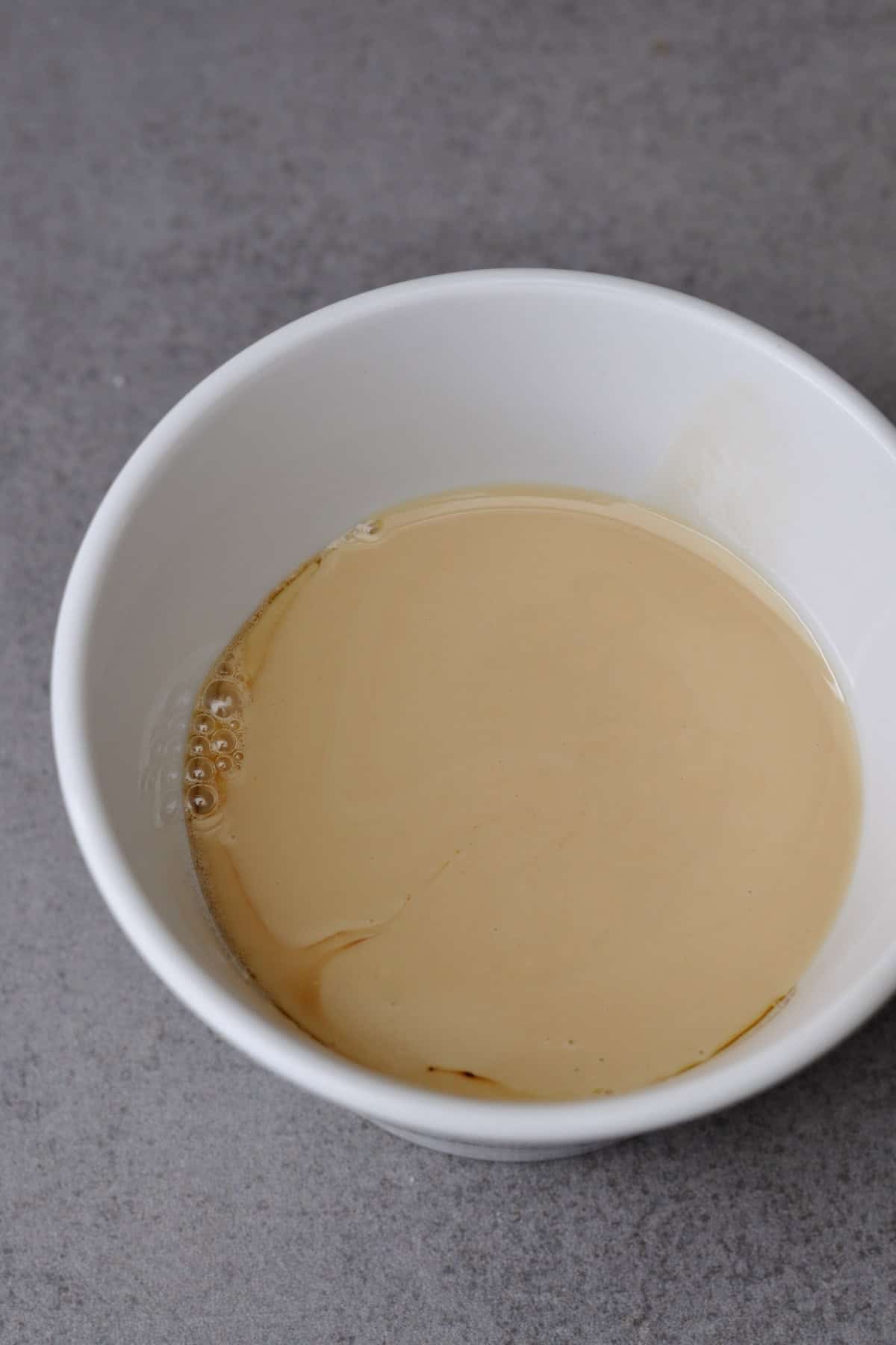 Maple syrup and tahini in a white bowl