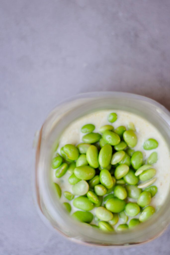 edamame with mix of Thai green curry paste and vegan yogurt in a jar