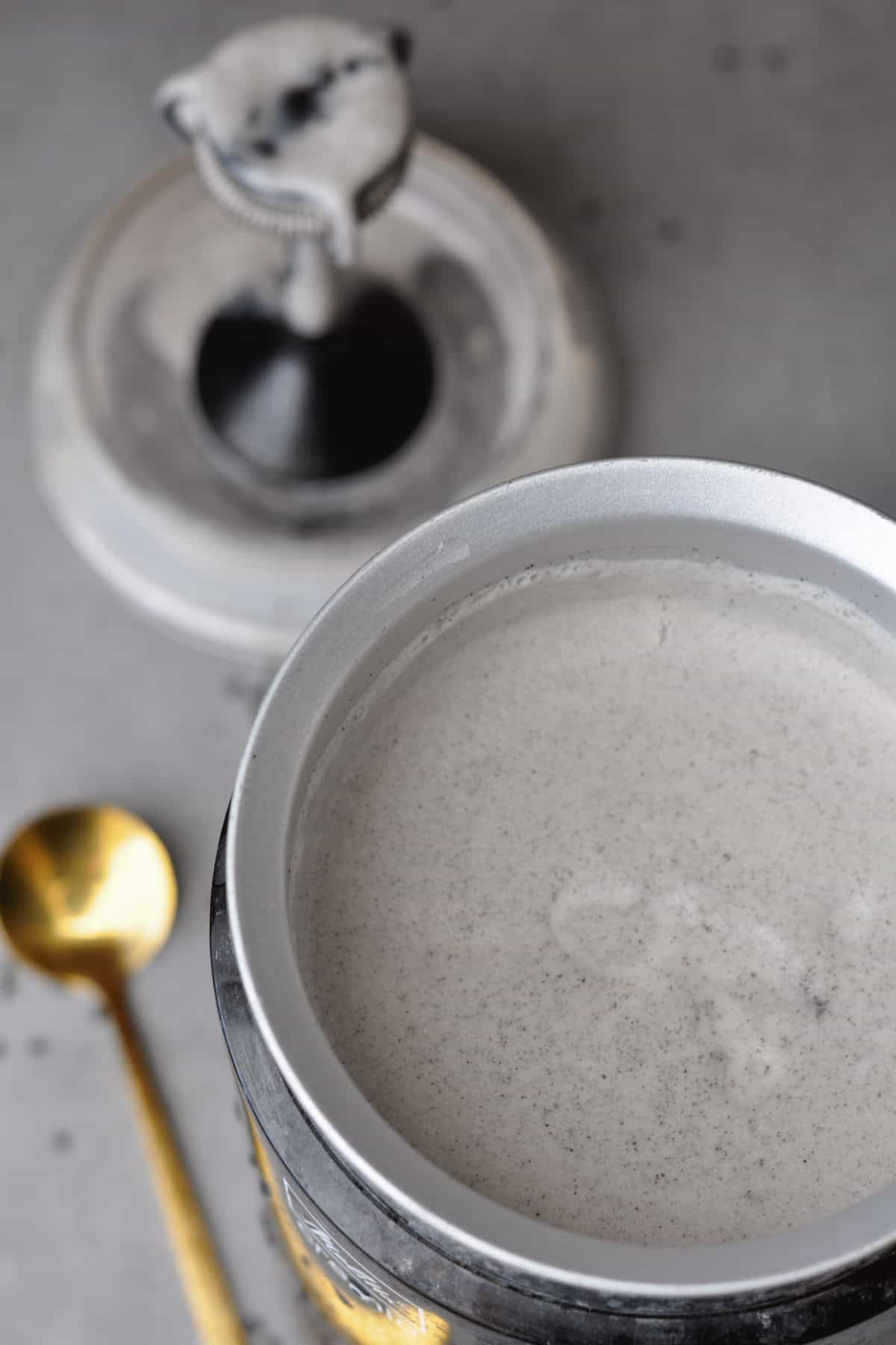 vegan black sesame latte in a milk frother