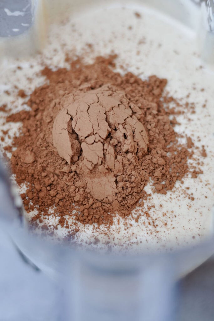 cocoa powder over a mix of cashew creme anglaise and hazelnut butter