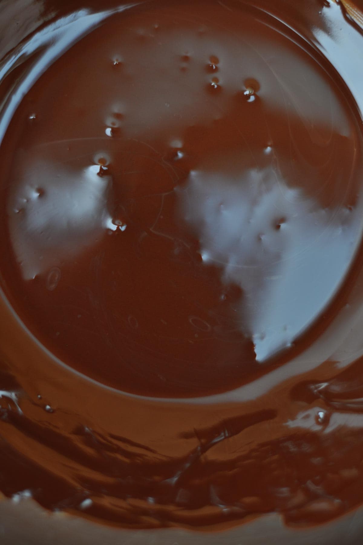 melted dark chocolate in a metal bowl. 