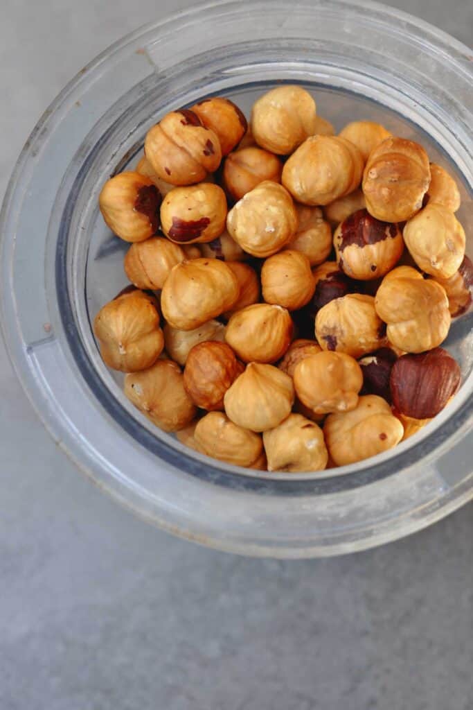 roasted hazelnuts in a small blender container.