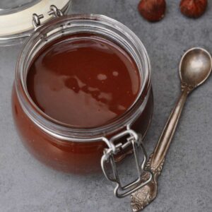 vegan gianduja chocolate spread in a small glass jar.