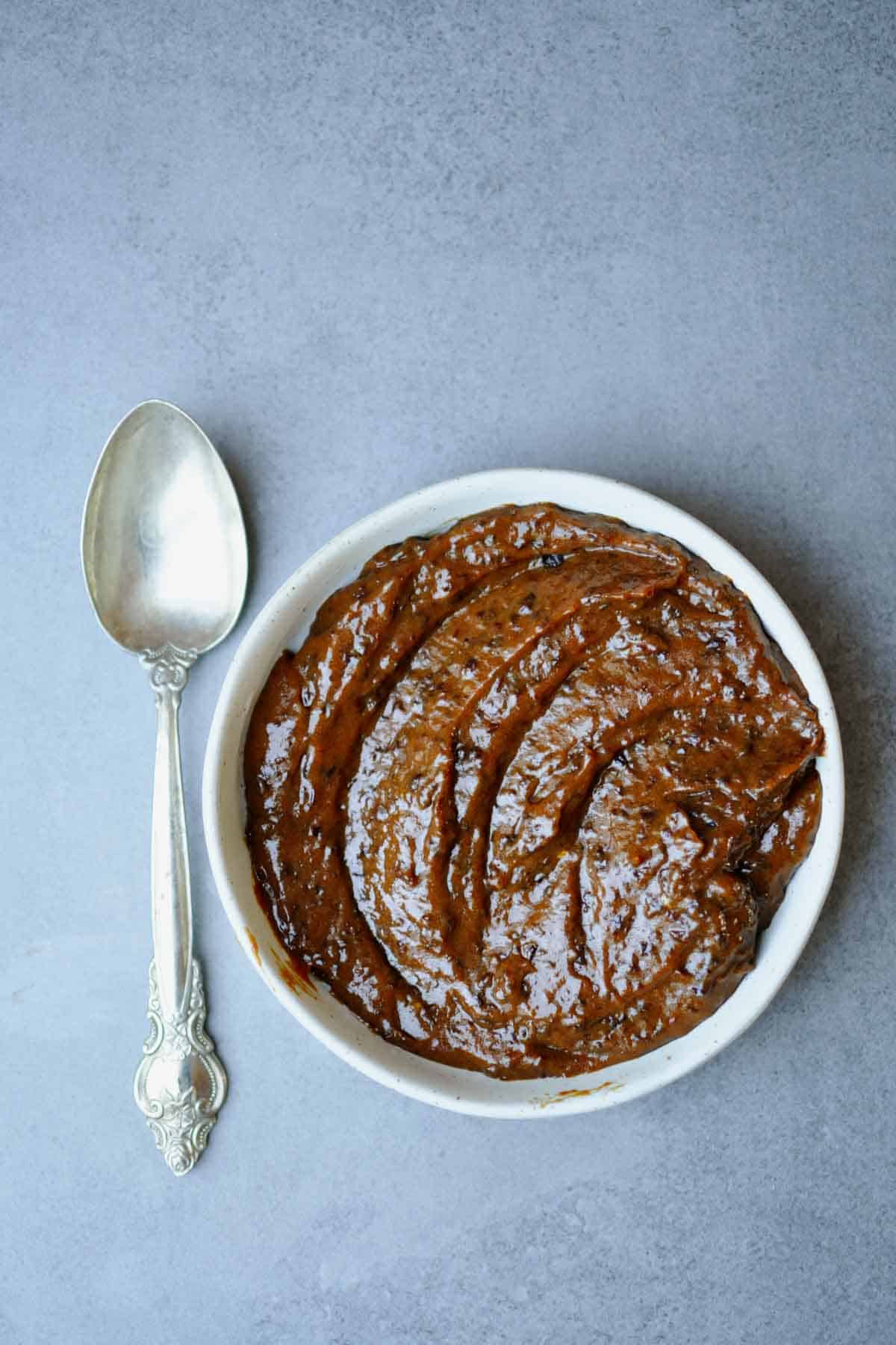 naturally sweet prune jam on a white plate.