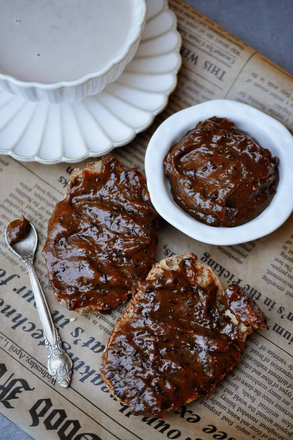 no-sugar prunes jam on two pieces of bread and a cup of hot cocoa.