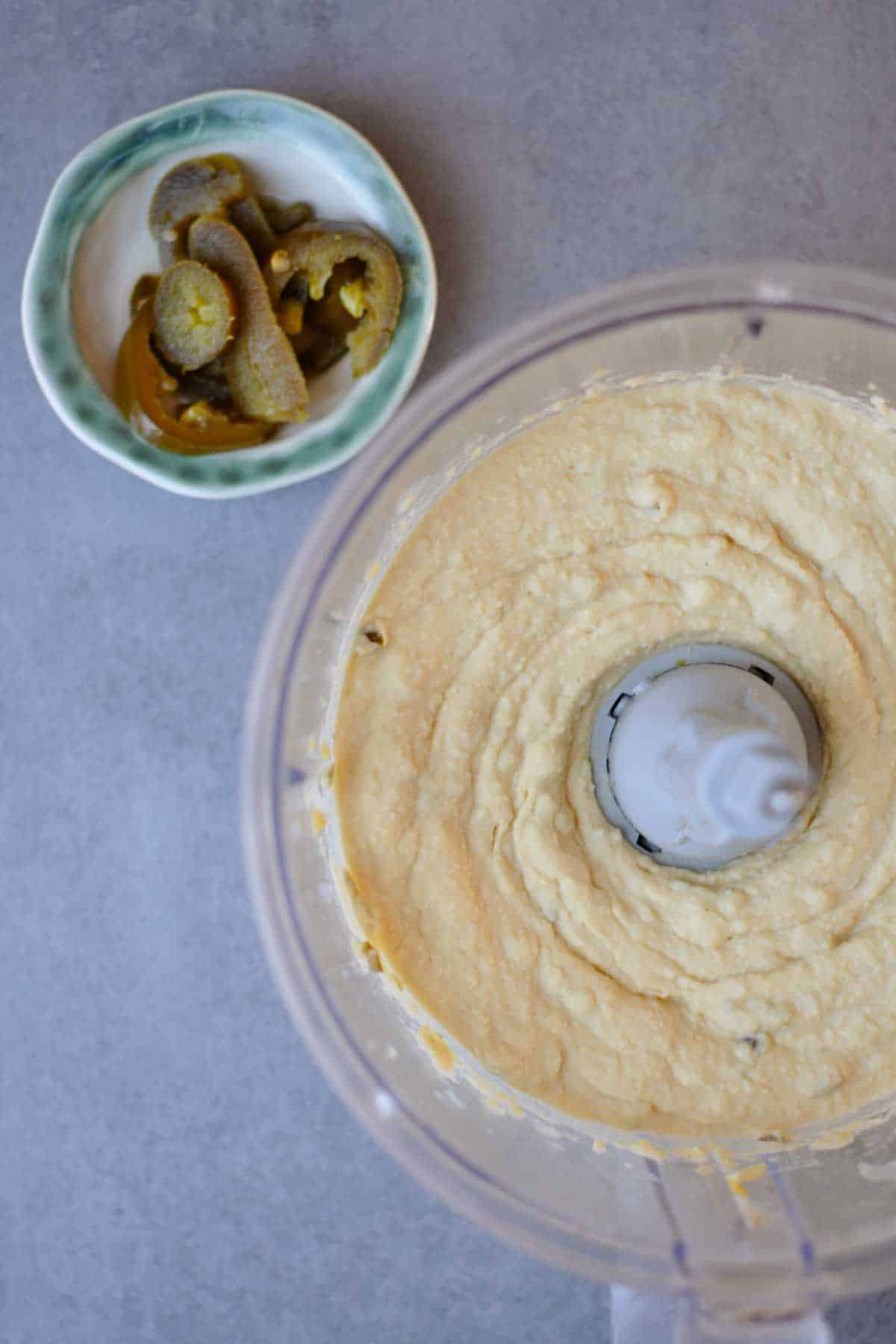 mixed spicy jalapeno hummus with minced pickled jalapeno in a food processor. 