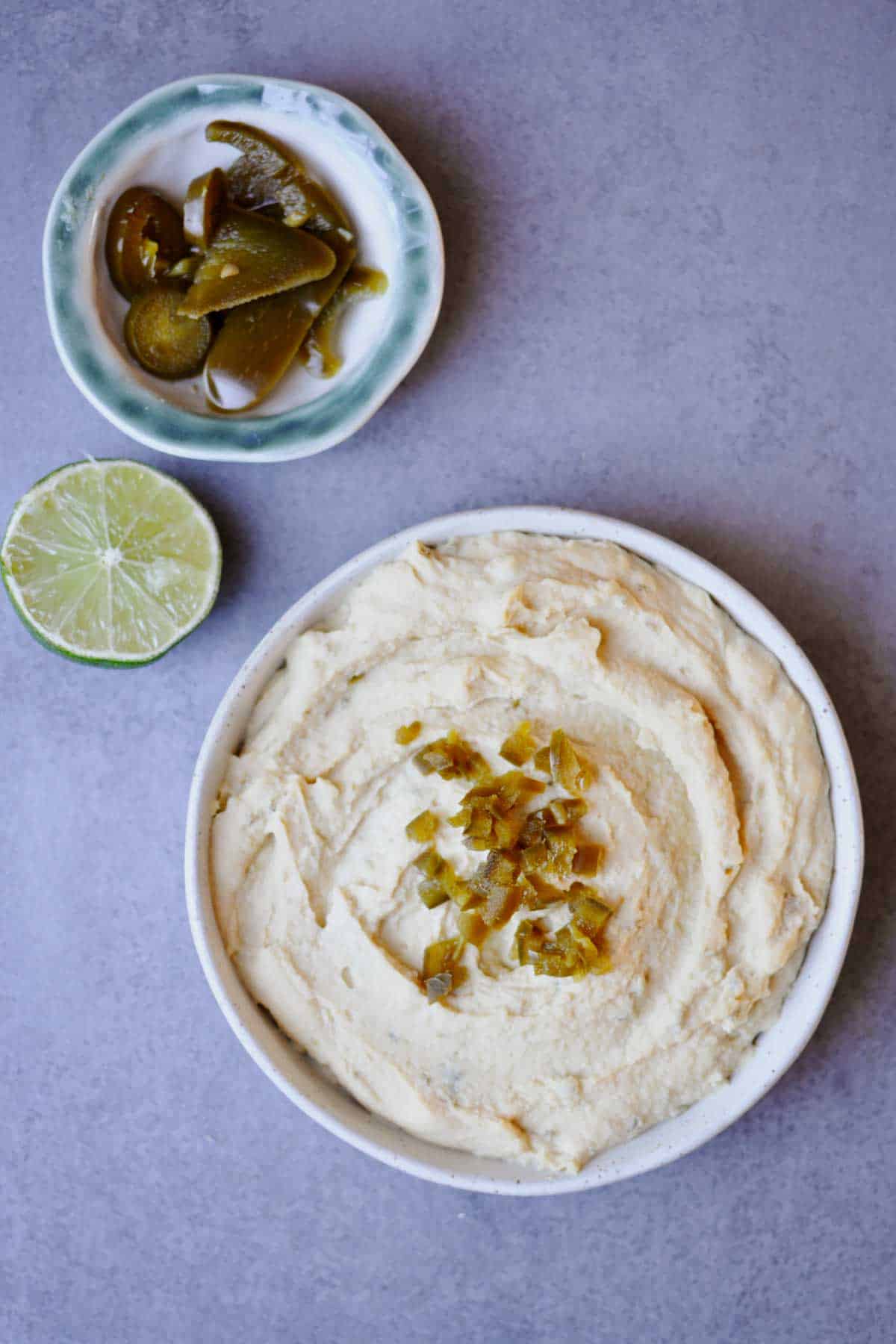 spicy jalapeno hummus on a white plate. 