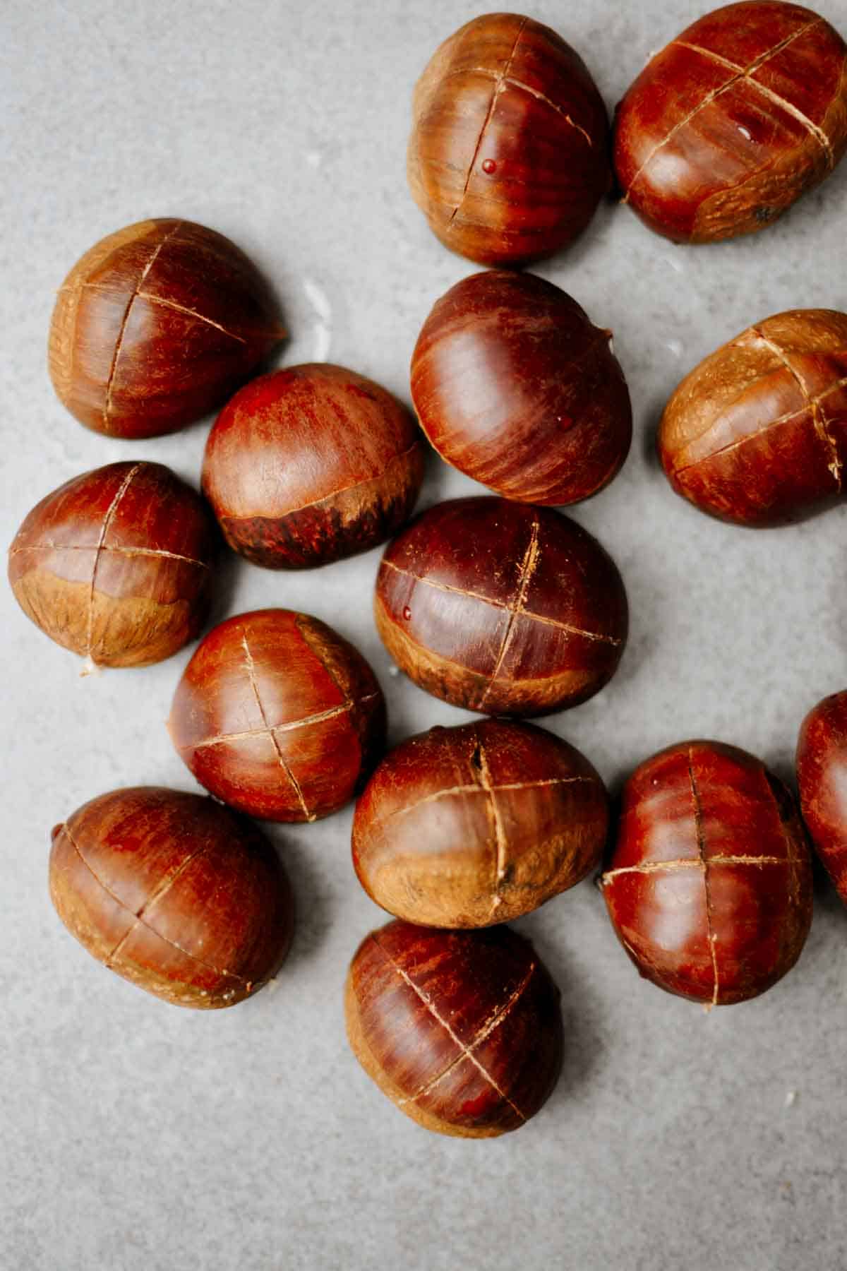 cut intalian chestnuts on a grey table.