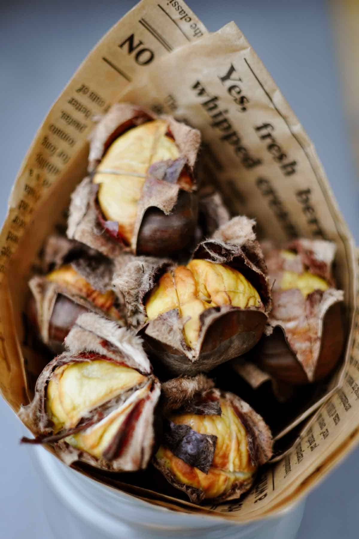 roasted chestnuts street vendor style in a paper cone.